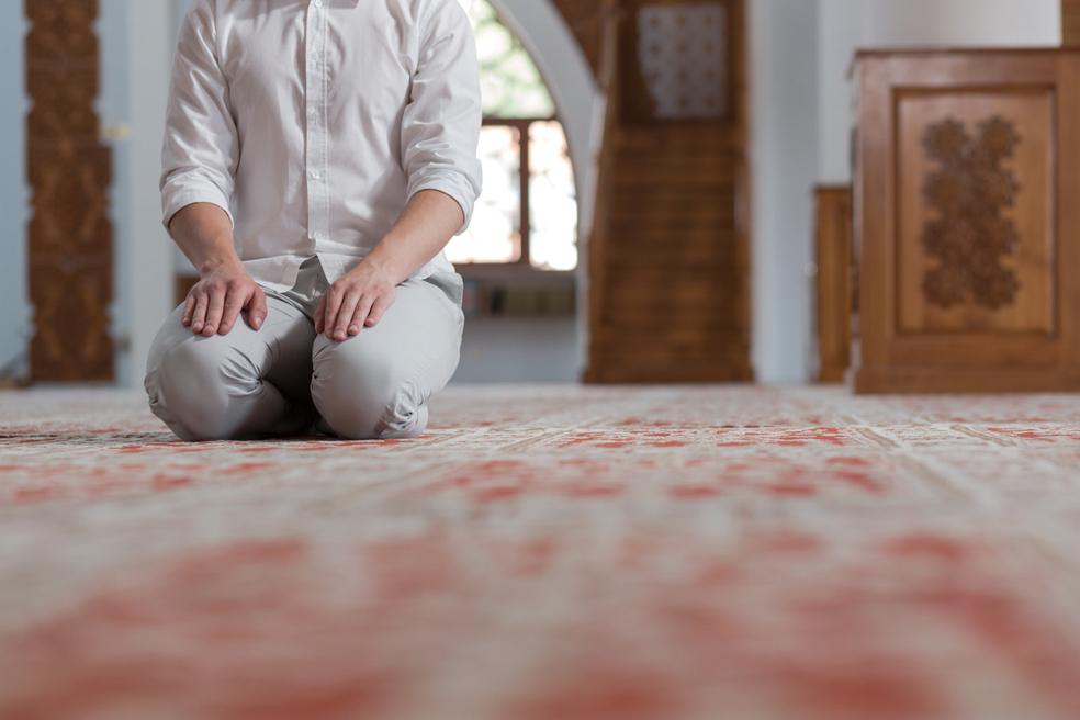 Religious muslim man praying inside the mosque