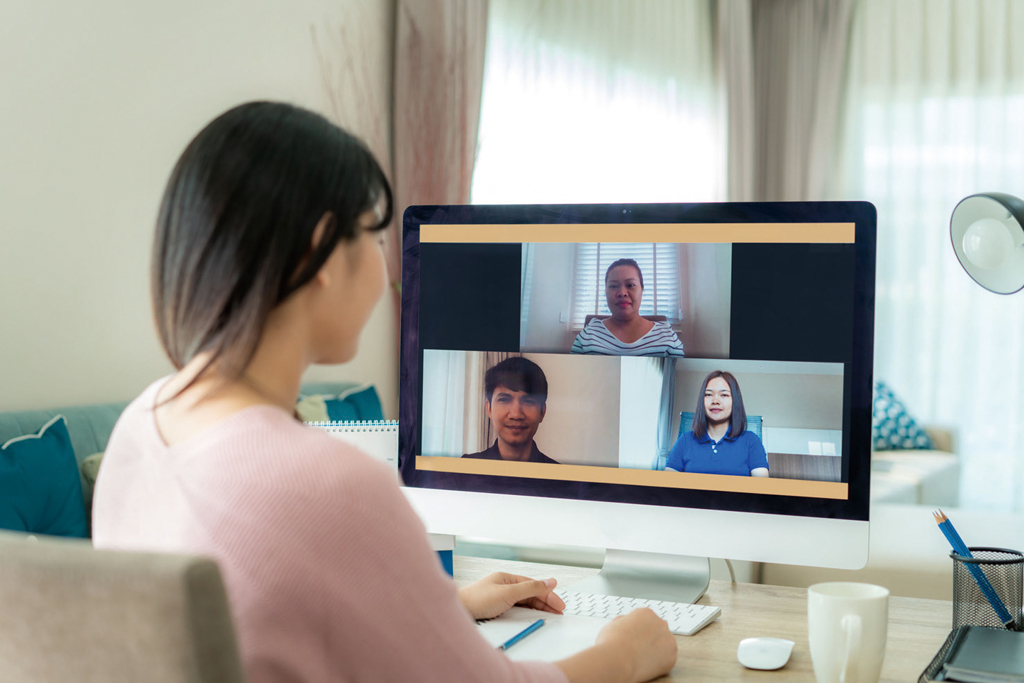 Back view of Asian business woman talking to her colleagues abou