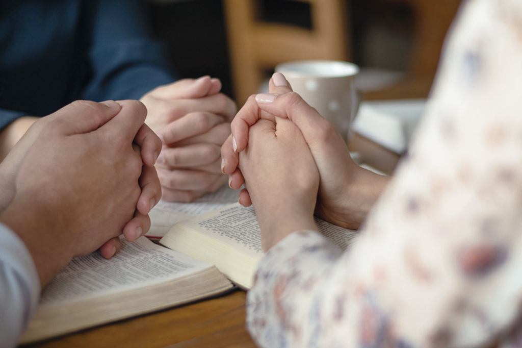 Christian worship and praise. Happy friends reading the bible together.