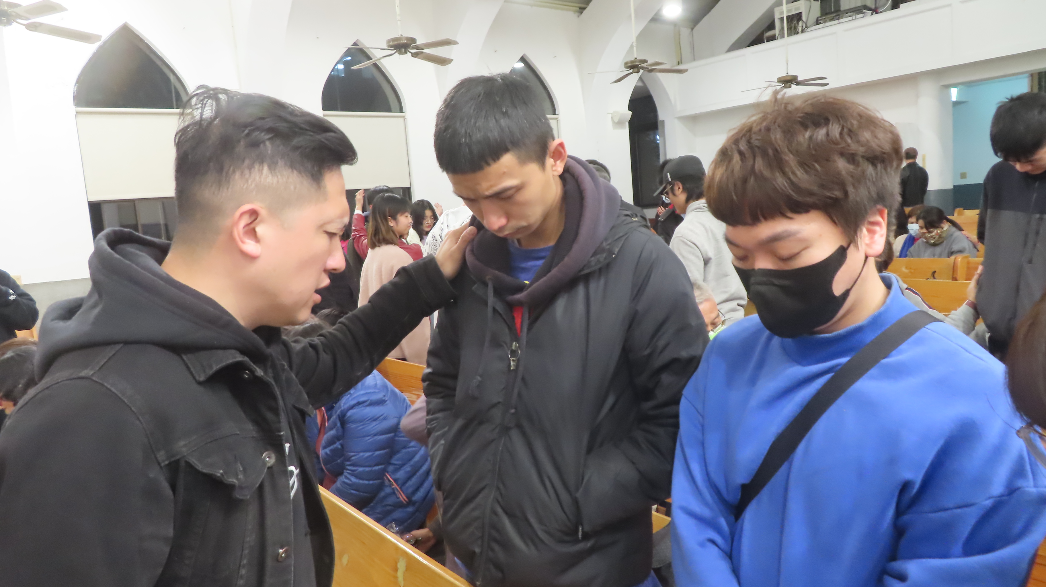 潘俊達牧師為回應呼召的年輕人祝禱。​（梁敬彥攝影）